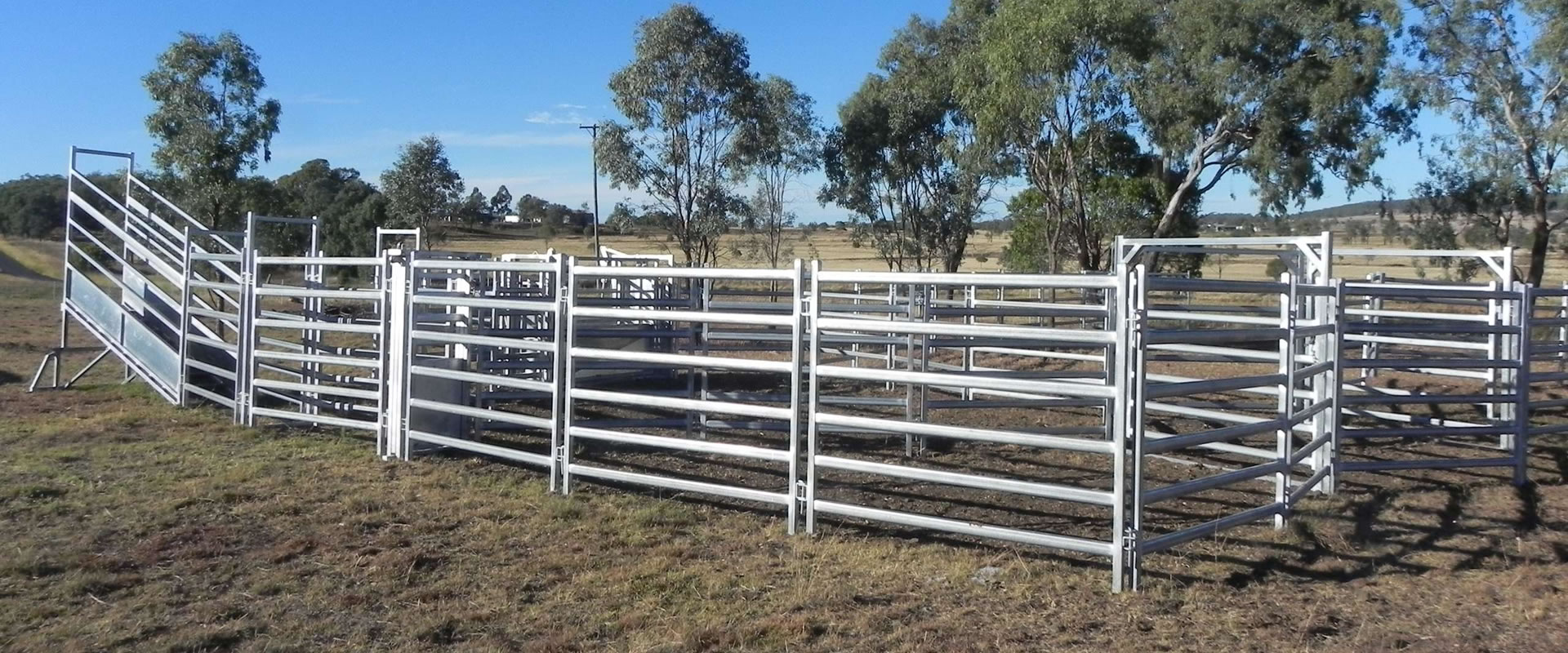 Several pieces of corral panels and loading ramp on the grassland.